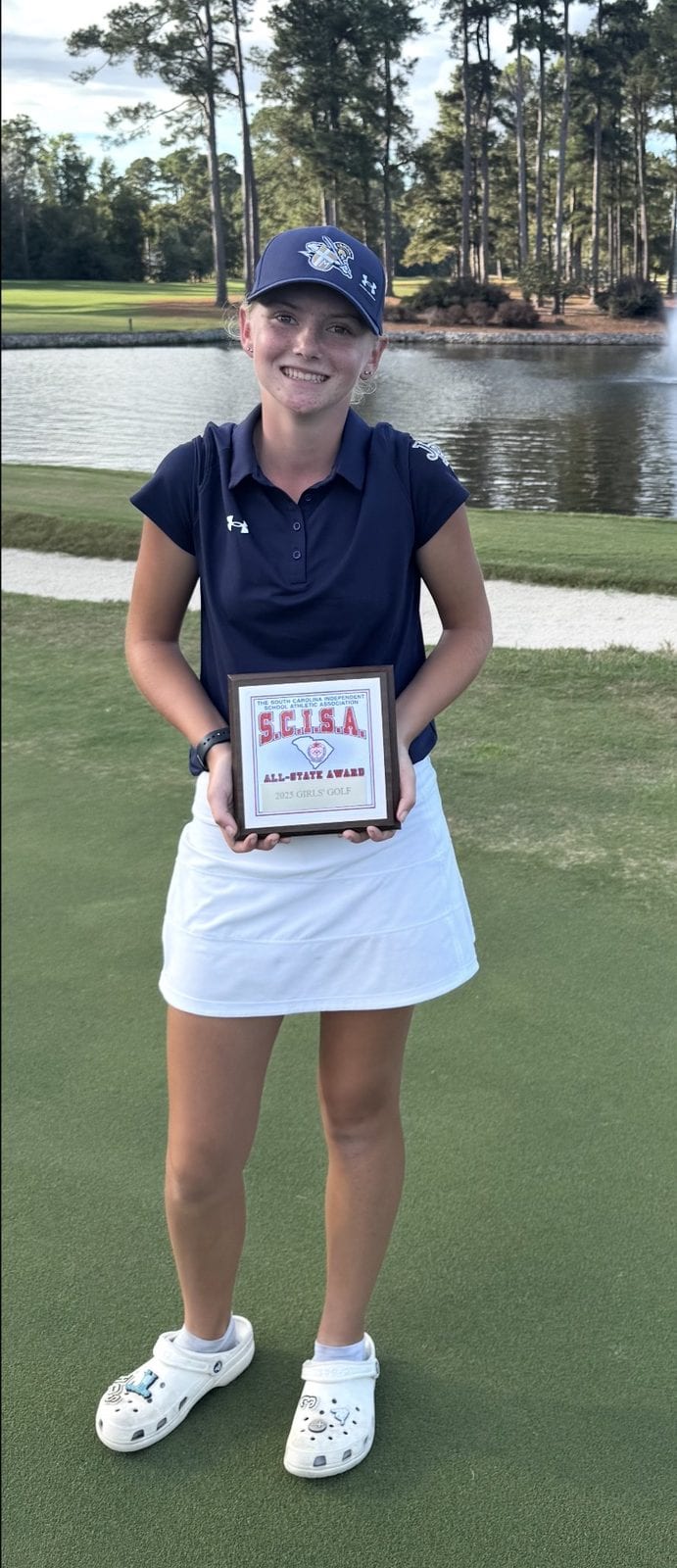 Sofie smiling while holding her SCISA All-State plaque.